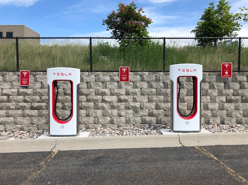 Image of a Tesla Supercharger station with multiple charging stalls lined up for Tesla electric vehicles.